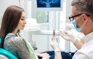 Dentist explaining details of how dental implants work