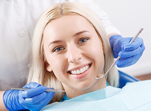 Smiling young woman in dental chair