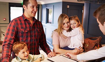 Family of four at reception desk in dental office