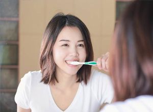 woman brushing teeth