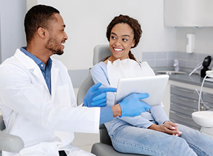 Dentist and patient having relaxed conversation