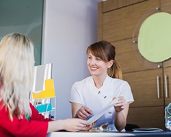 Woman learning about her options for paying for dentures