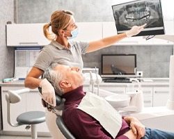 Dentist and patient reviewing X-ray