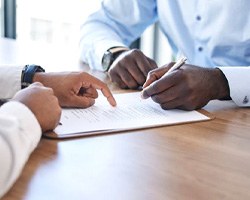 Two people conferring over insurance documents