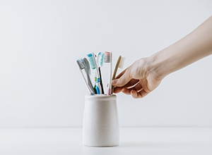 Person reaching for their toothbrush