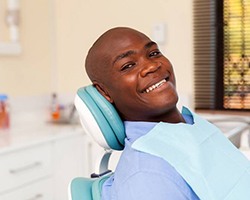 Man smiles after getting dental implants in Enfield