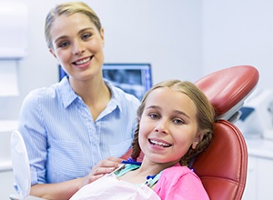 Child in dental chair with dentist
