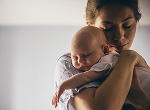 Woman holding a sleeping baby