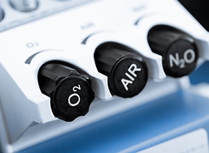 Close-up of black control dials on nitrous oxide machine