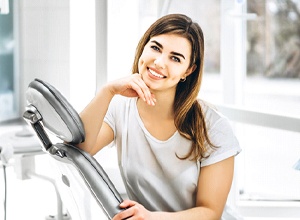 Smiling dental patient in gray shirt with beautiful, white teeth