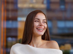 Smiling, attractive woman with braces on her teeth