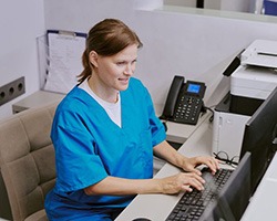 Dental team member working on computer