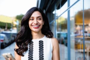 woman enjoying straight teeth after using Invisalign promotion