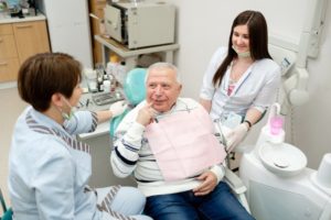 Elderly man visiting dentist for seniors in Enfield