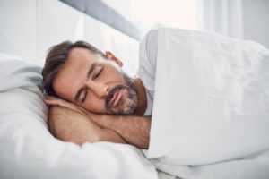 Man in bed, going through the stages of sleep in Enfield