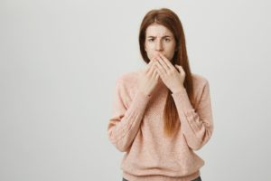 Frowning woman, concerned about loose tooth in Enfield