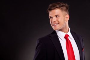 Young man in suit, wearing braces