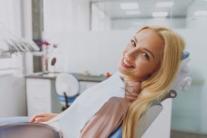 Smiling, happy dental patient in treatment chair