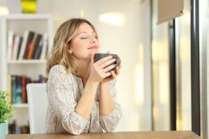 Woman enjoying a cup of coffee in her office