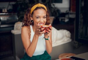 Happy young woman enjoying a cup of coffee